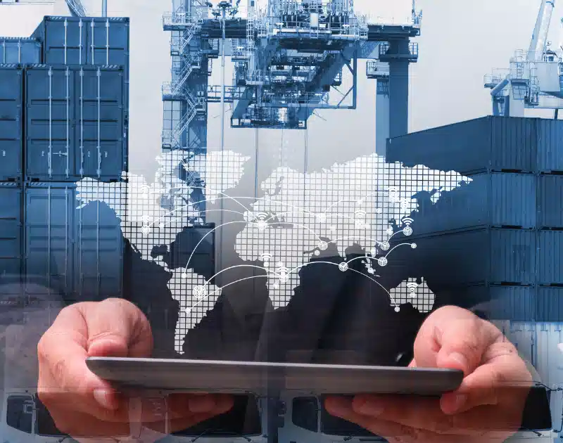 Man holding a tablet being superimposed on images of map, containers, and cranes