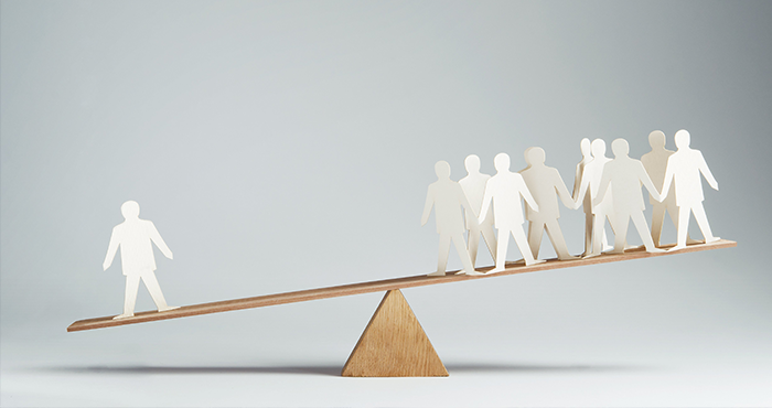 Large group of paper cut-out people outweighs individual