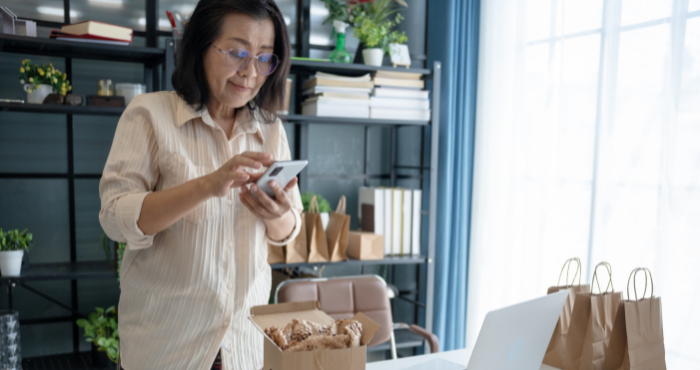 Small business owner checking her phone in an office