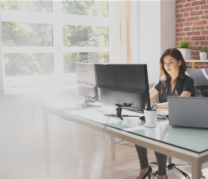 women in an office building on a computer representing looking at property taxes
