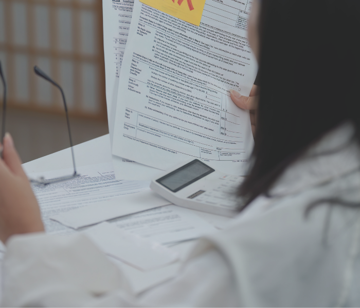 woman reviewing tax paperwork at a desk