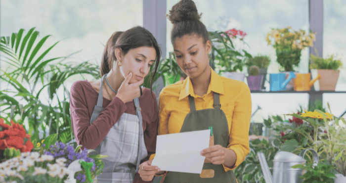 Two small business owners discussing their tax documents