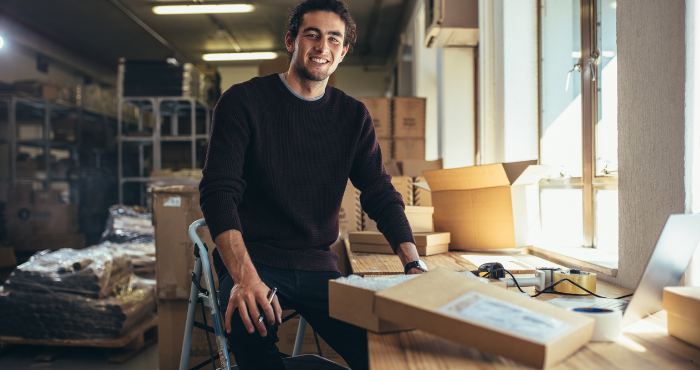 Small business employee packing items into boxes