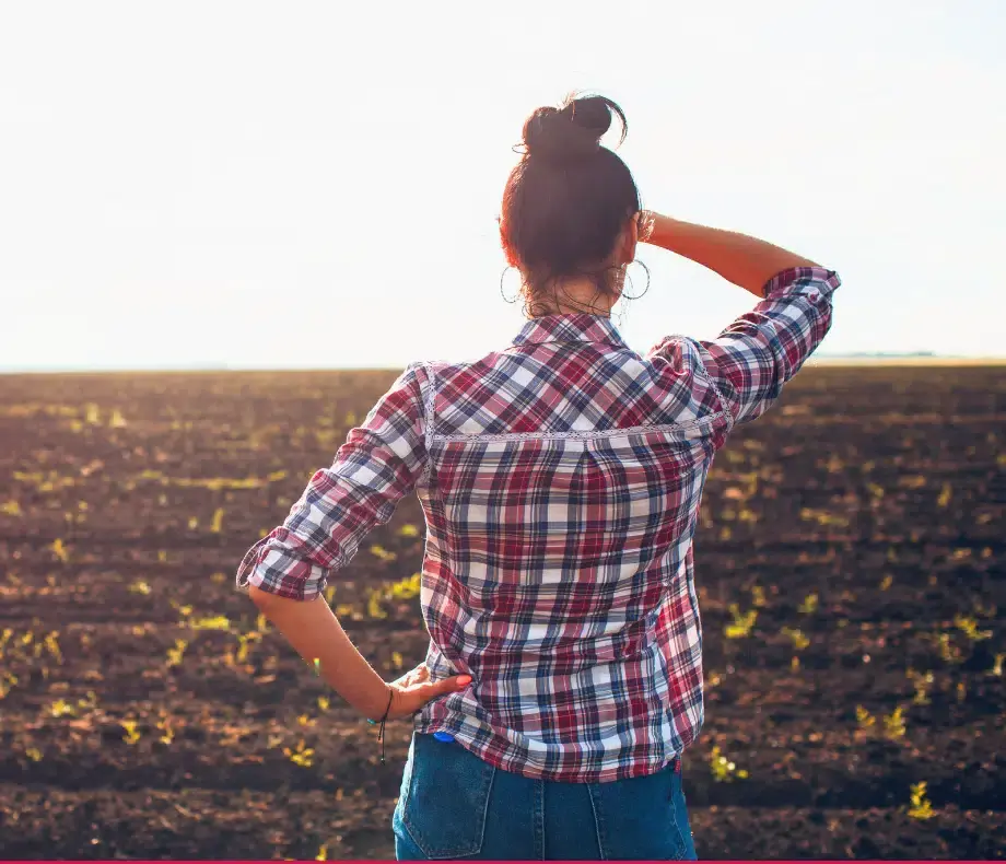 Farmer looking at her farm