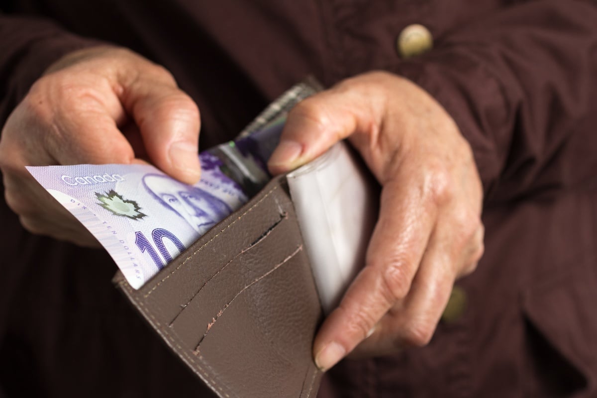 man taking money out of his wallet