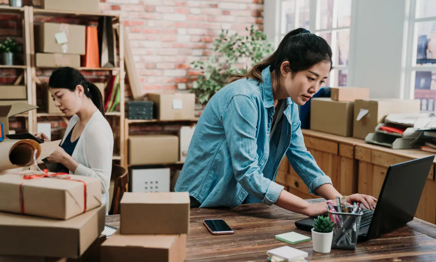 Two small business owners preparing their packages to be delivered