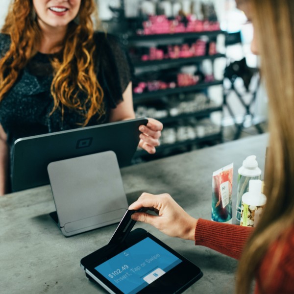 Small business owner accepting a credit card payment from one of her customers