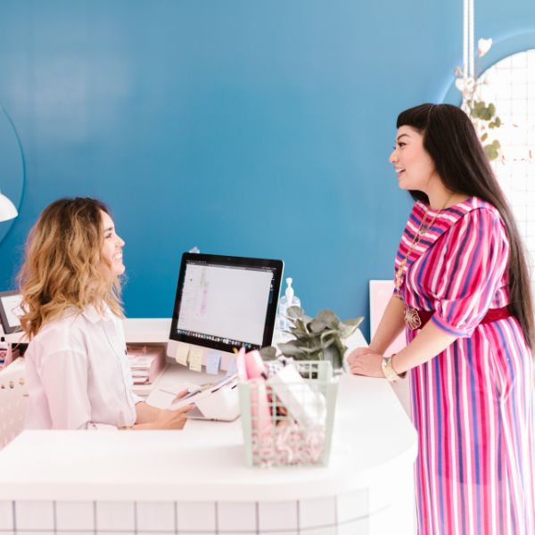 Small business owner talking with one of her customers in her store