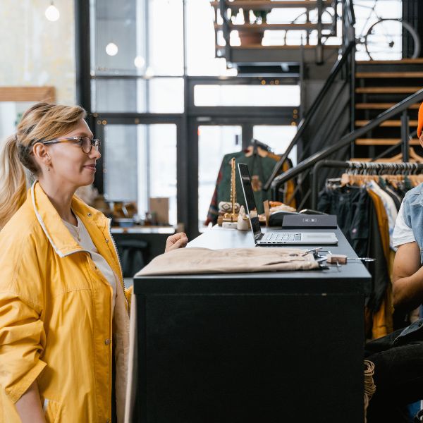 Small business owner in Quebec talking with one of her customers in her store