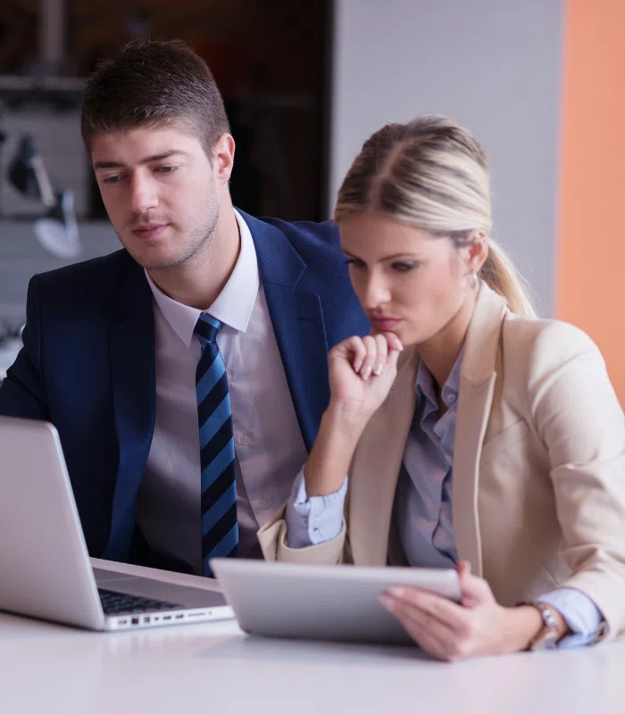 Two small business owners looking at their laptop