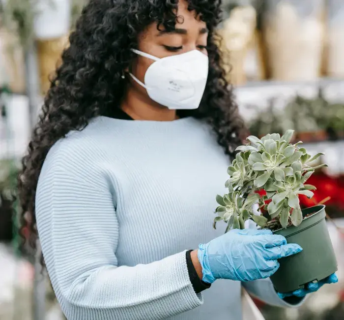 Small business owner wearing a mask in her shop