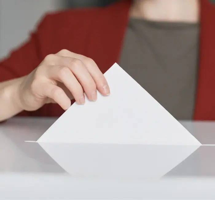 Small business owner casting her vote in the ballot box
