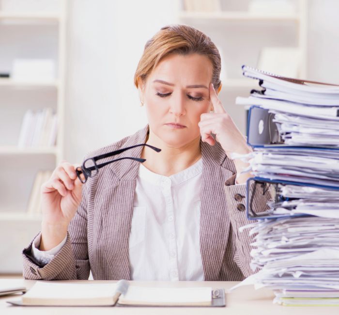 Small business owner overwhelmed by paperwork