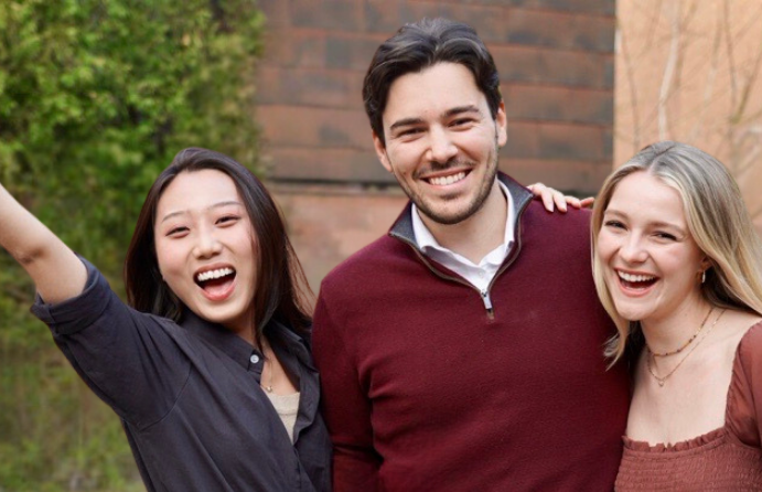 Three interns from CFIB's 2022 cohort standing next to each other and smiling. 